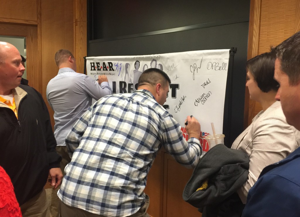 Participants in the HEAR training at Harvard sign the "I Respect Others" commitment banner. The students they teach will have the opportunity to sign a banner, which can be displayed in the school.